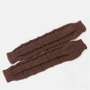 Detailed texture of dark brown knit arm warmers with a unique wave checkered 3D pattern
