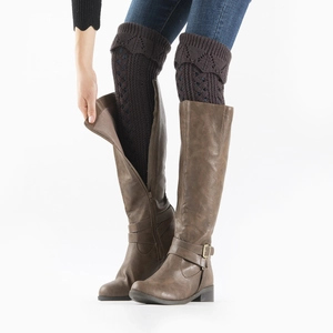 Detail of dark brown cable knit boot toppers paired with brown leather tall boots