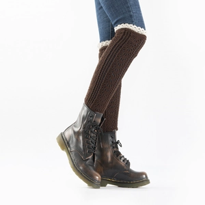 Close-up of knit leg warmers with lace trim and vertical cable patterns in coffee brown
