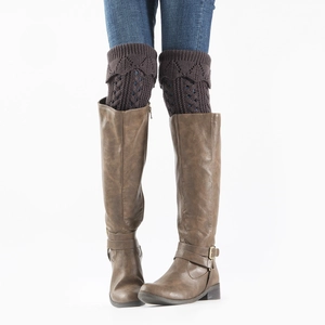 Close-up of dark brown hollow knit leg warmers with diamond pattern and scalloped cuff