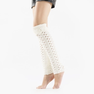 Detailed texture of white open knit leg warmers with hollow mesh and ribbed cuffs