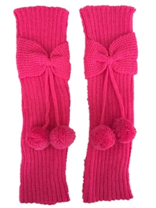 Detail of bright pink knitted leg warmers with decorative bows and plush pom-poms