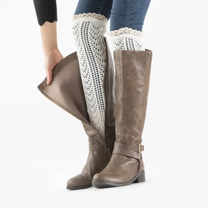 Detail of dark brown tall boots with side zipper and white lace knitted leg warmers