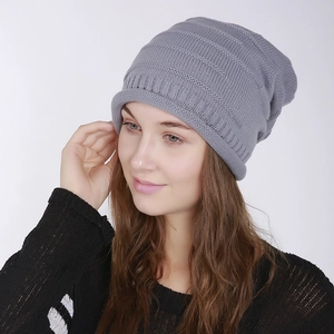 Close-up of grey ribbed knit beanie showing soft texture and horizontal stripe pattern