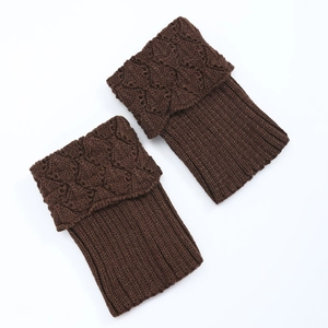 Detailed cable knit pattern on dark brown acrylic leg warmers with ribbed texture
