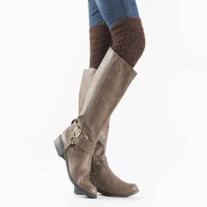 Detail view of brown leather boots with stylish hollowed-out knit leg warmers for women