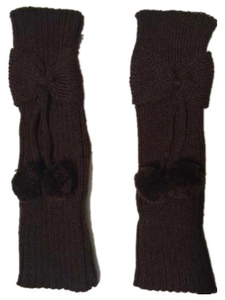 Detail of dark brown knitted leg warmers with bow and fluffy pompom pendants