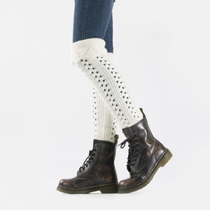Detailed knit texture of cream over-knee leg warmers with hollow diamond patterns