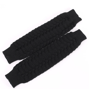 Detail of black wave pattern knit leg warmers showing ribbed cuffs and thick texture