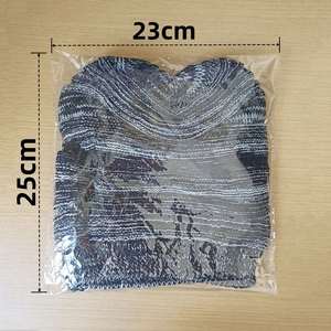 Flat lay detail of a striped knit beanie showing size measurements 23cm by 25cm