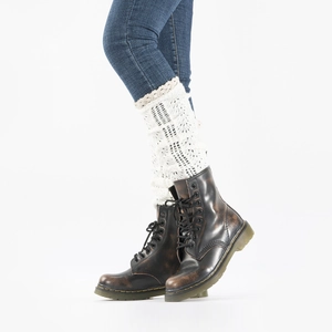 Detail showing white crochet leg warmers with lace trim worn with brown leather boots