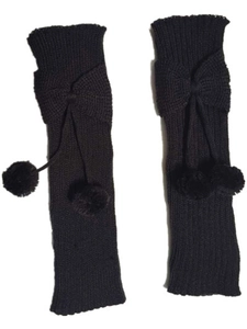 Close-up of black knitted leg warmers with ribbon bows and soft decorative plush balls