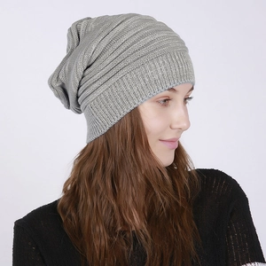 Detail view of the chunky knit texture and vertical ribbed pattern on a gray beanie