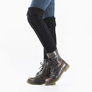 Close-up of black cable knit leg warmers with hollow scalloped edge detail