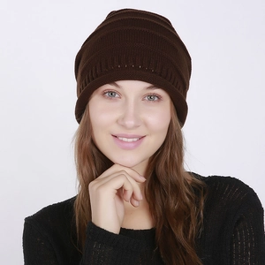 Detailed macro view of dark brown knitted beanie showing fine horizontal ribbed texture