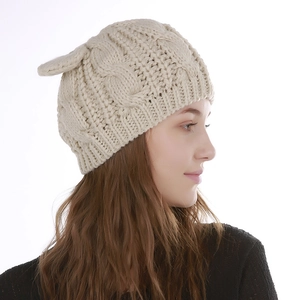 Winter women's cream cable knit beanie featuring cute cat ears and thick warm texture