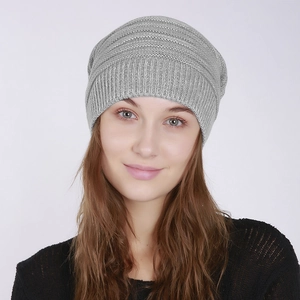 Detail of light grey ribbed knit slouchy beanie shown on a model against white background