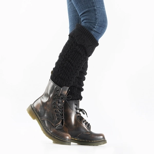 Detail of black cable knit leg warmers showing intricate hollow crochet texture