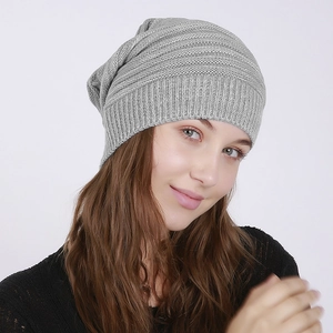 Macro shot showing the detailed ribbed texture and soft grey knit of the slouchy beanie