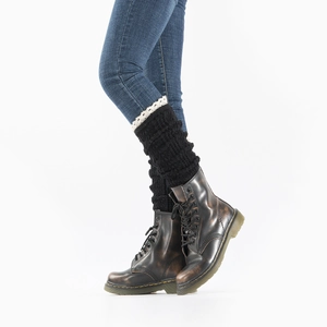 Detail of black knit leg warmers with white lace trim paired with vintage brown boots