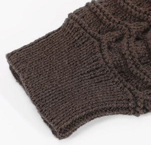 Detailed close-up of dark brown knit leg warmer showing ribbed cuffs and cable patterns