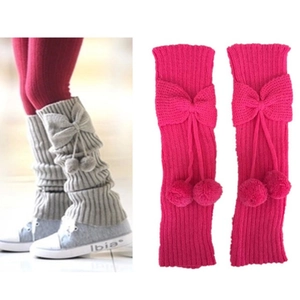Girl's knit leg warmers with cute bow and pom-poms in grey and rose pink colors