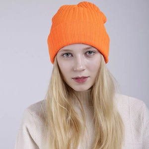 Double-layered bright orange knit beanie with ribbed texture for winter skiing warmth