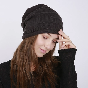 Close-up of black ribbed knit beanie showing textured details and premium fabric finish