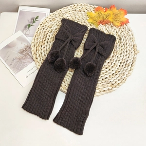 Winter rib-knit leg warmers for kids featuring cute bowknot and fuzzy pom-poms in dark brown