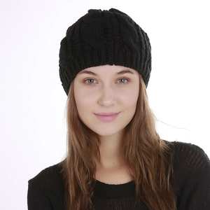 Detail of black knitted beanie featuring classic cable pattern and cat ear design