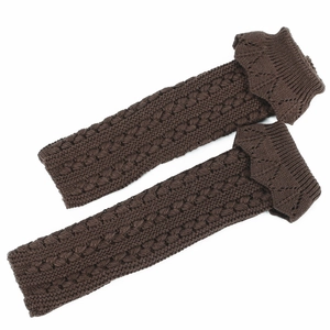 Detailed texture of dark brown cable knit leg warmers with scalloped edge trim