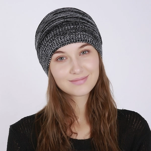 Close-up of black and white mixed knit beanie showing soft textured yarn on a model