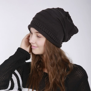 Close-up of black ribbed knit beanie showing soft texture and folded cuff style