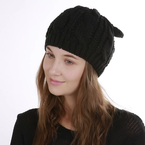 Close-up of black cable knit beanie featuring cute cat ear design for winter warmth