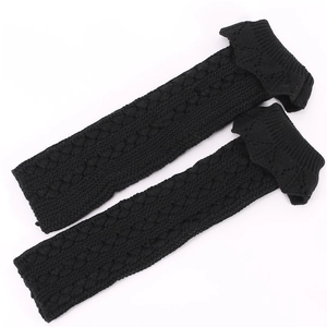 Close-up of cable knit texture and ruffled top on black leg warmers for women