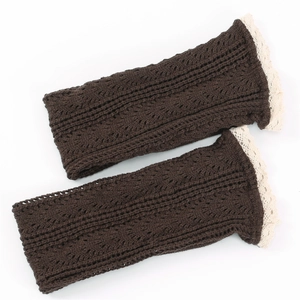 Detailed close-up of dark brown knit leg warmers with delicate cream lace embroidery edges