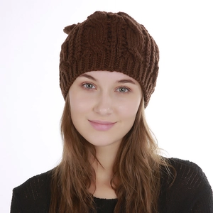 Close-up of the chunky knit texture and classic cable weave on this brown winter beanie