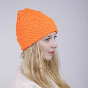 Close-up of bright orange double-layer ribbed knit beanie showing warm winter texture