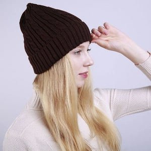 Detail of dark brown cable knit beanie with folded cuff and soft fleece lining