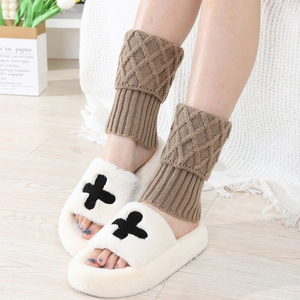 Plush cross slippers with brown cable knit leg warmers for cozy winter indoor wear