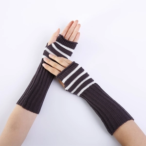 Detailed view of long striped knitted fingerless gloves with elastic ribbed texture