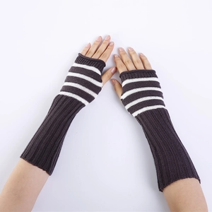 Close-up of gray knitted fingerless gloves with white stripes and thumb hole design