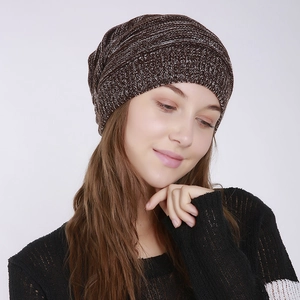Detail of mixed-color pleated knit beanie in brown and white with soft texture