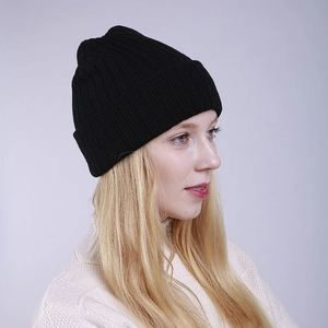 Close-up of black ribbed knit beanie showing the thick double-layer texture and warm material
