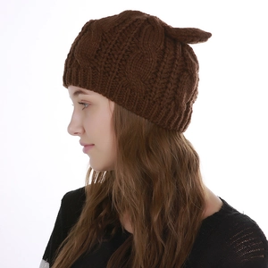 Close-up of brown cable knit beanie with cute cat ears worn by model in side profile