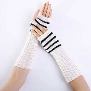 Close-up of white knitted fingerless long arm sleeves with black striped hand patterns