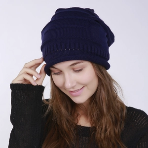 Detailed knit texture of navy blue pleated beanie with horizontal ribbed patterns