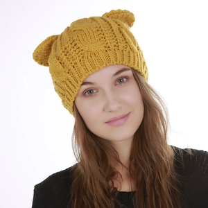 Detail of ginger yellow knit beanie with cute animal ears and thick cable texture