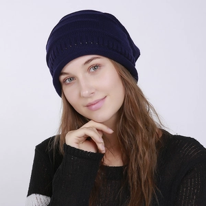 Detailed close-up of dark blue knit beanie showing ribbed texture and wave patterns