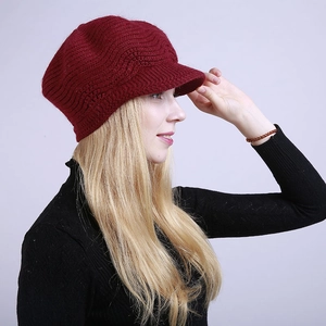 Close-up of wine red knitted beret hat showing thick wavy texture and sturdy sun visor
